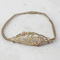 OroAmerica solid 10K gold #1 Mom bracelet with two tone floral accents and lobster claw clasp