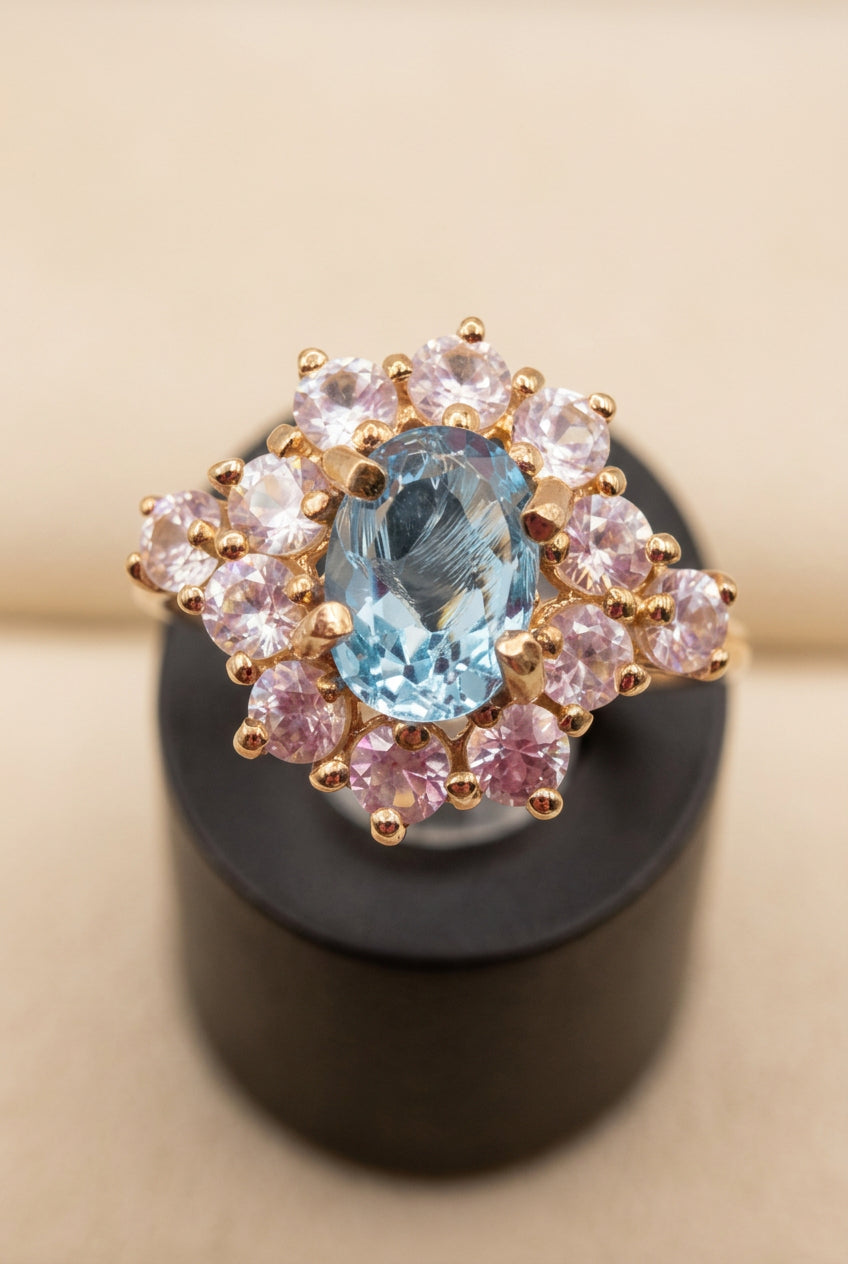 SGF Solid 10K Yellow Gold Ring with Oval Blue Topaz Center Stone Framed by a Halo of Round White Sapphires