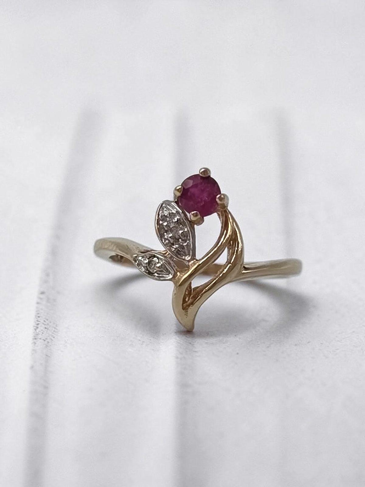 Solid 10K Yellow Gold Ring with Round Ruby and Two Diamonds Set in Leaf Plates with Swirl Gallery Size 4