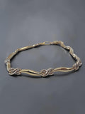Solid 10K two tone gold criss cross X link wave station bracelet measuring 7.25 inches