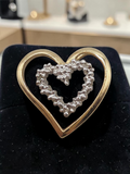 Solid 10K two tone gold double heart pendant with three diamond accents
