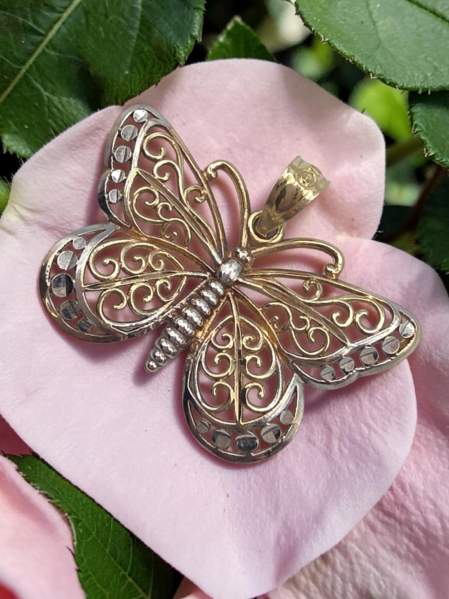Solid 10K two tone gold filigree butterfly pendant with openwork scrollwork wings
