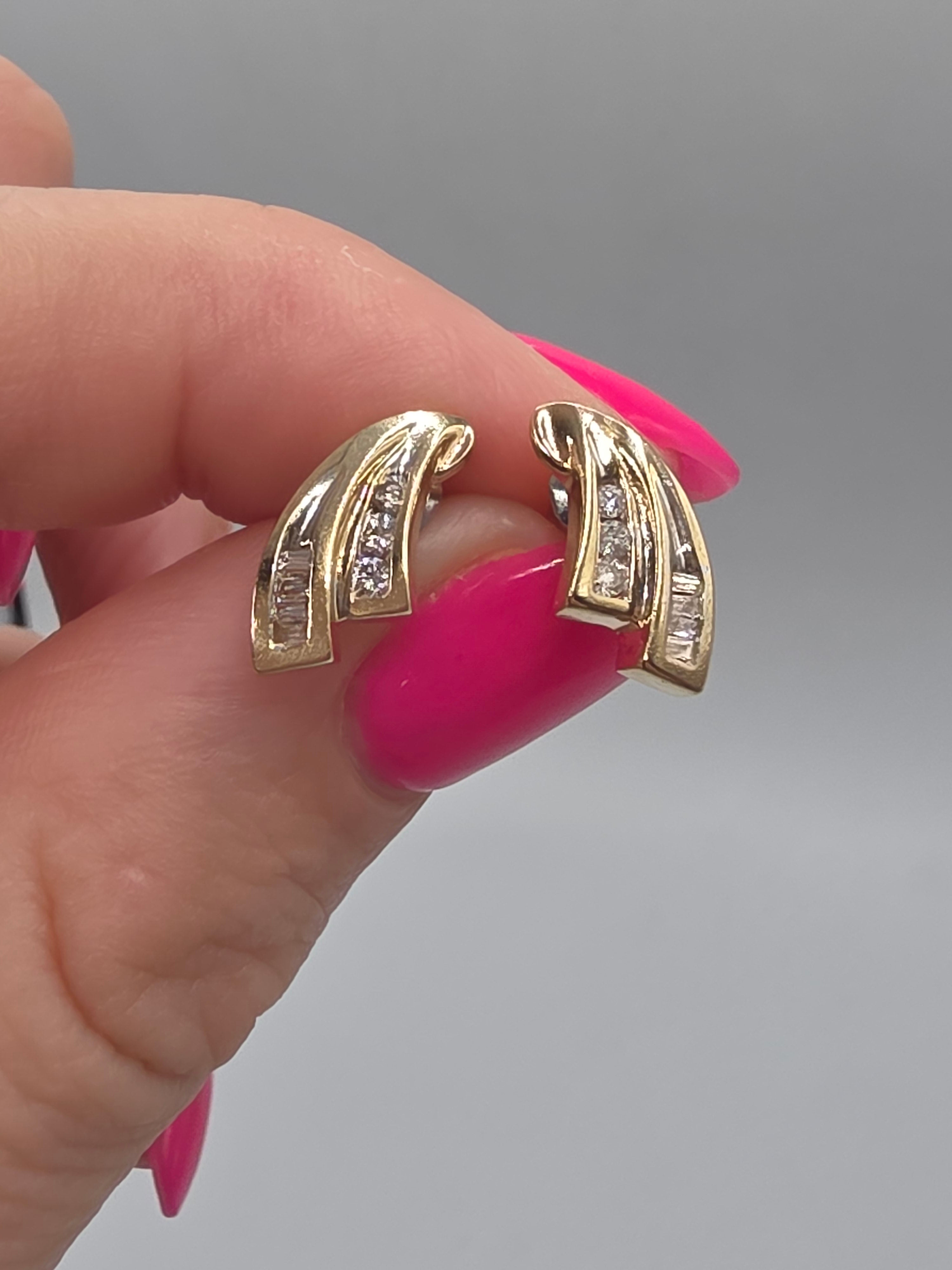 Solid 10K yellow gold round and baguette diamond swirl stud earrings