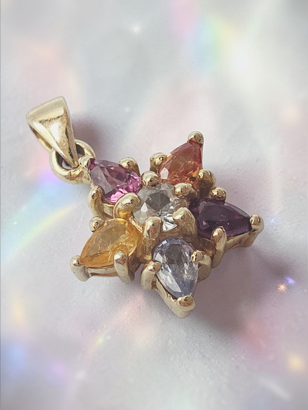 Solid 10K yellow gold star pendant with white topaz center and multicolor pear shaped gemstone points