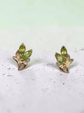Solid 14K yellow gold marquise peridot floral stud earrings with diamond accents