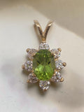 Solid 14K yellow gold oval peridot pendant with sparkling CZ halo flower design