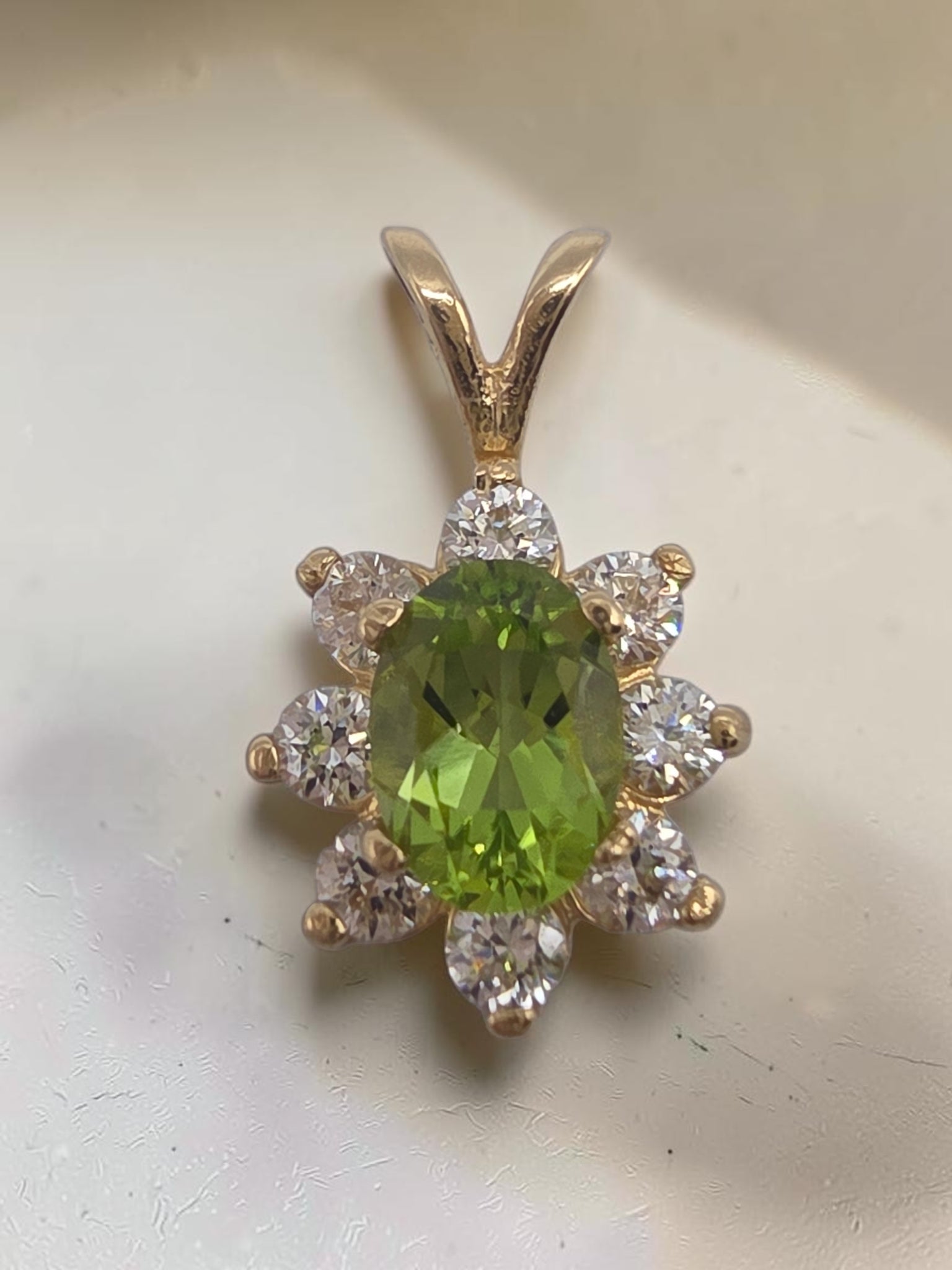 Solid 14K yellow gold oval peridot pendant with sparkling CZ halo flower design