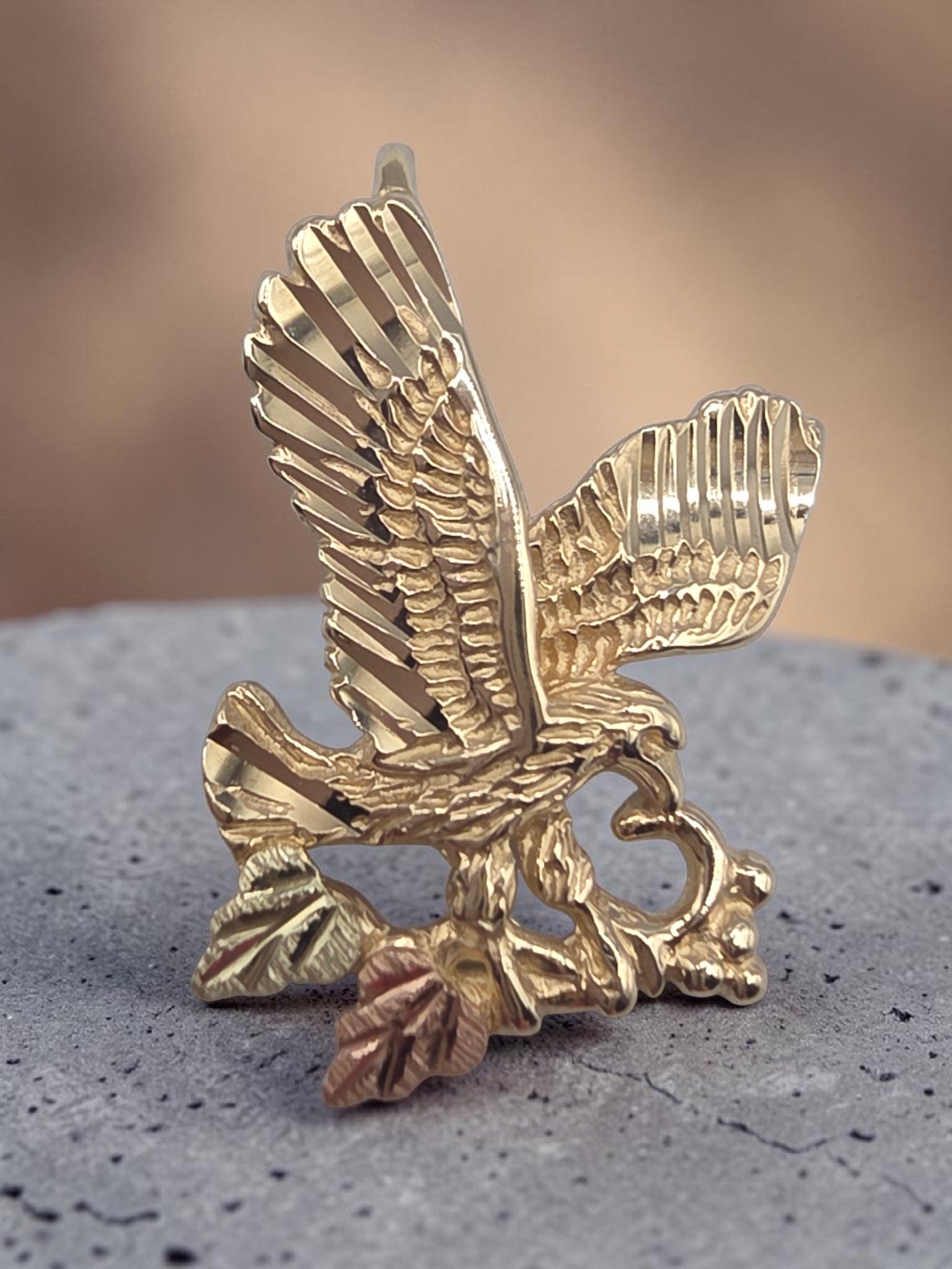 Vintage Black Hills Gold solid 10K tri-color soaring eagle pendant with 12K rose and green grape leaves